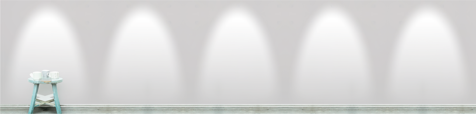 A plain grey wall with spotlights