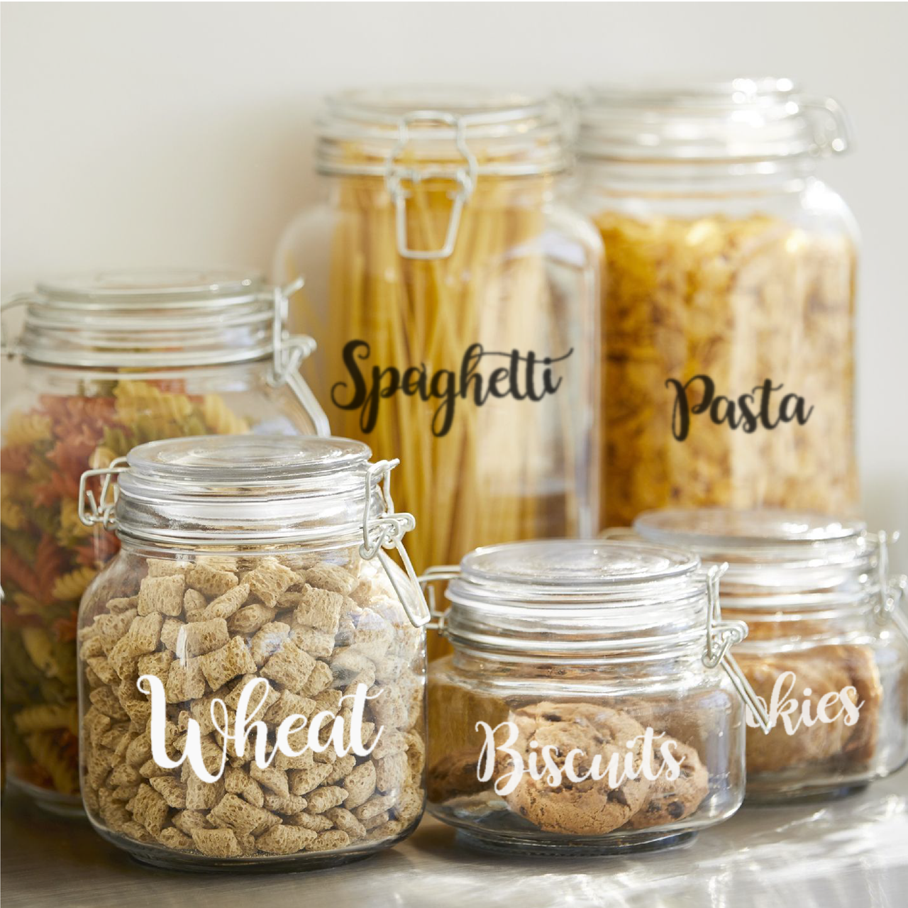 Six kilner jars with kitchen pantry decals applied to them
